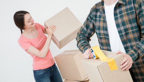 House removalists carrying furniture through a residential street in Abbeywood