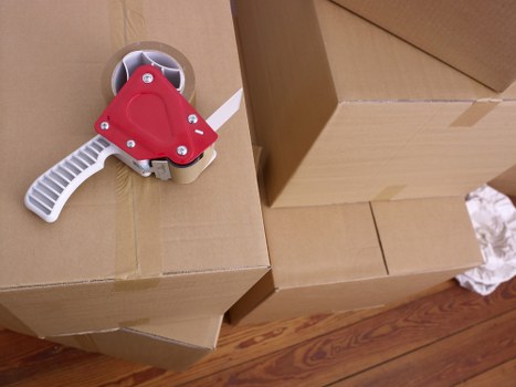 Packed office equipment and labelled boxes ready for relocation